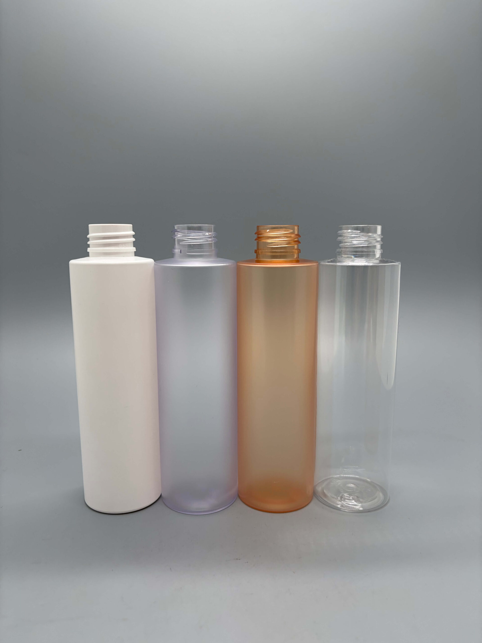 Cylindrical pump bottles in clear frosted and amber finishes