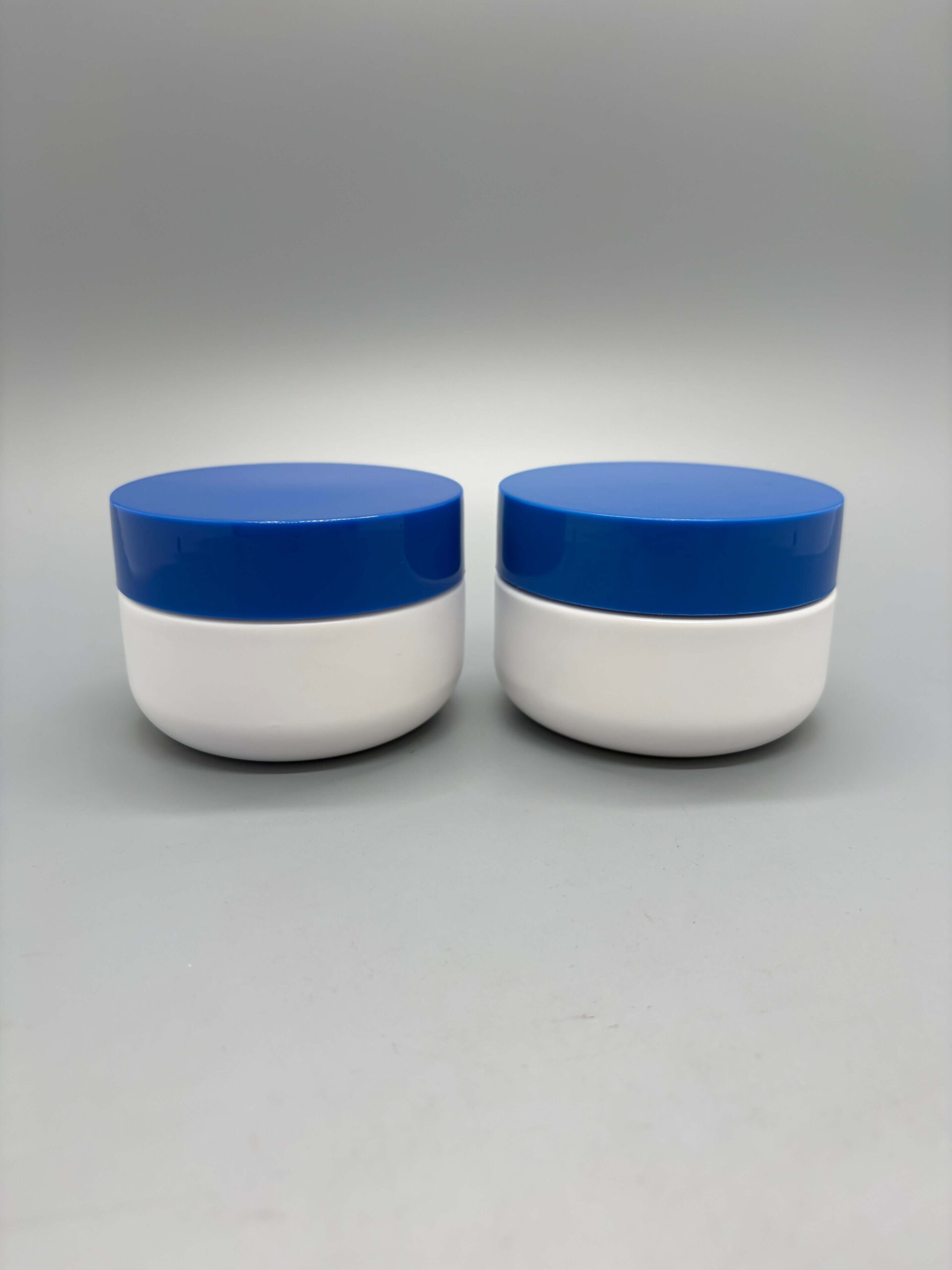 Wide-mouth cosmetic jars with blue screw lids